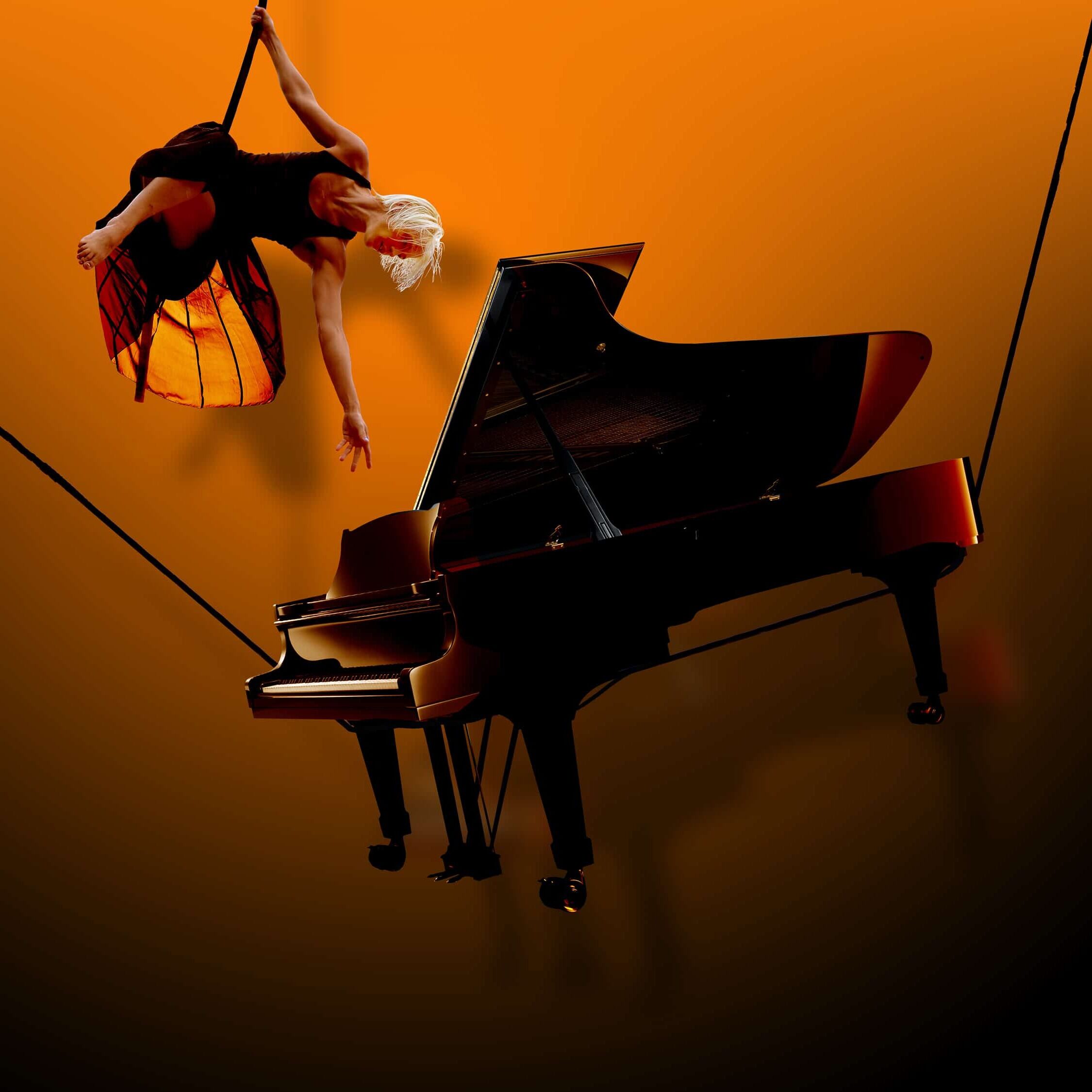 Gould's Wall: A woman suspended in the air reaching towards a piano, also suspended