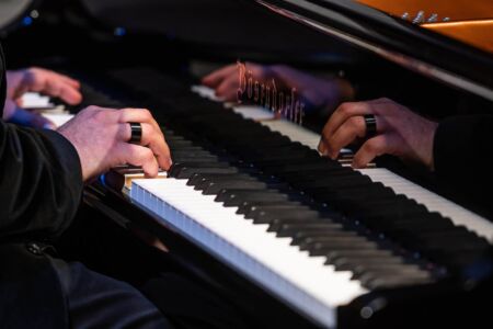 Photo by Dahlia Katz Close up of Robi Botos's hands at the Bosendorfer Imperial Grand piano