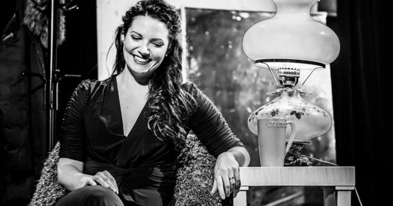 Photo of Mireille Asselin by Dahlia Katz Mireille Asselin sitting in a chair and smiling